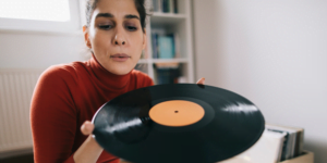 woman cleaning a vinyl record