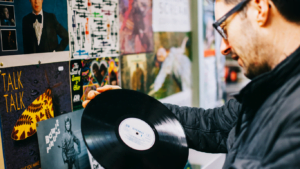 a man examines a vinyl record
